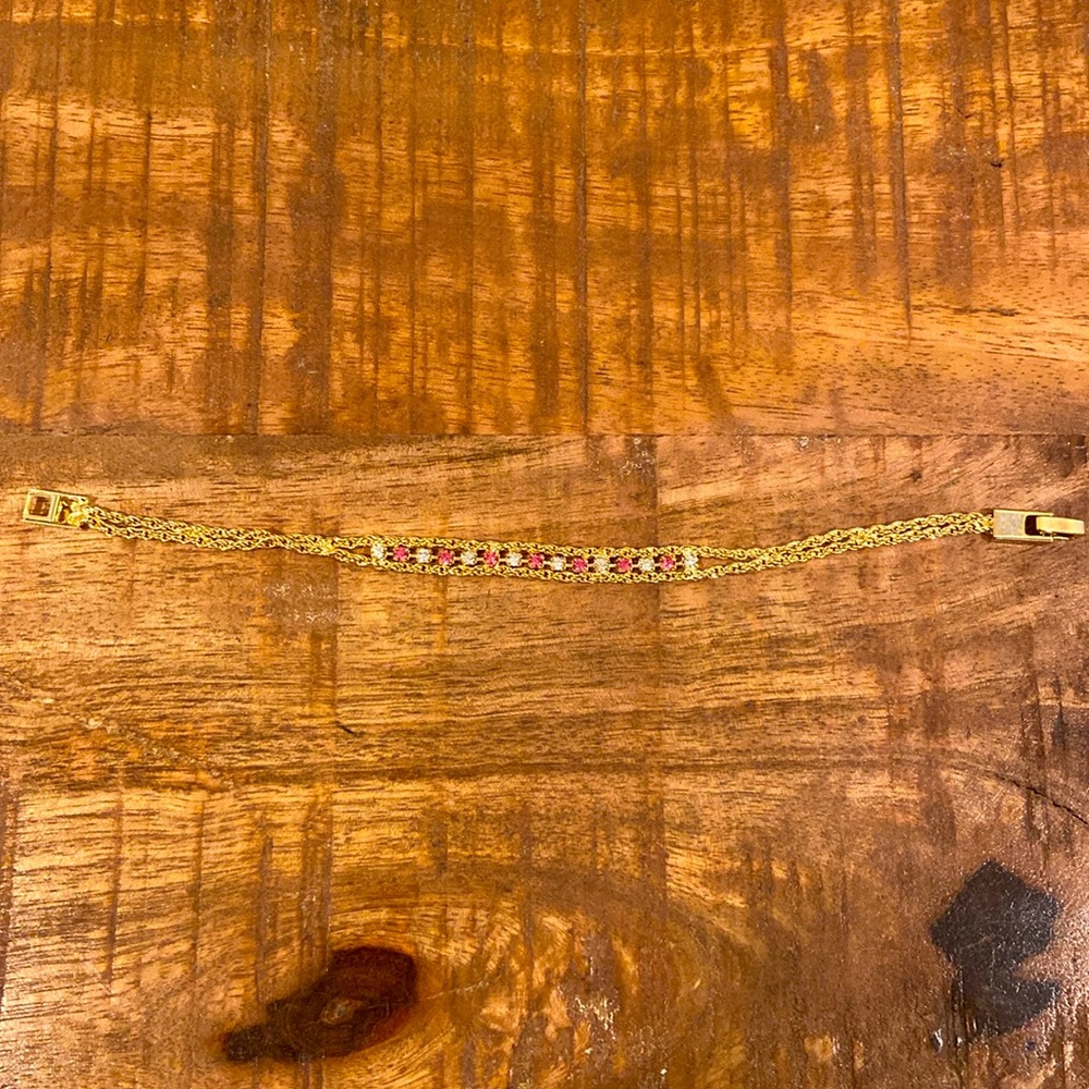 Gold plated bracelet with white and pink gems